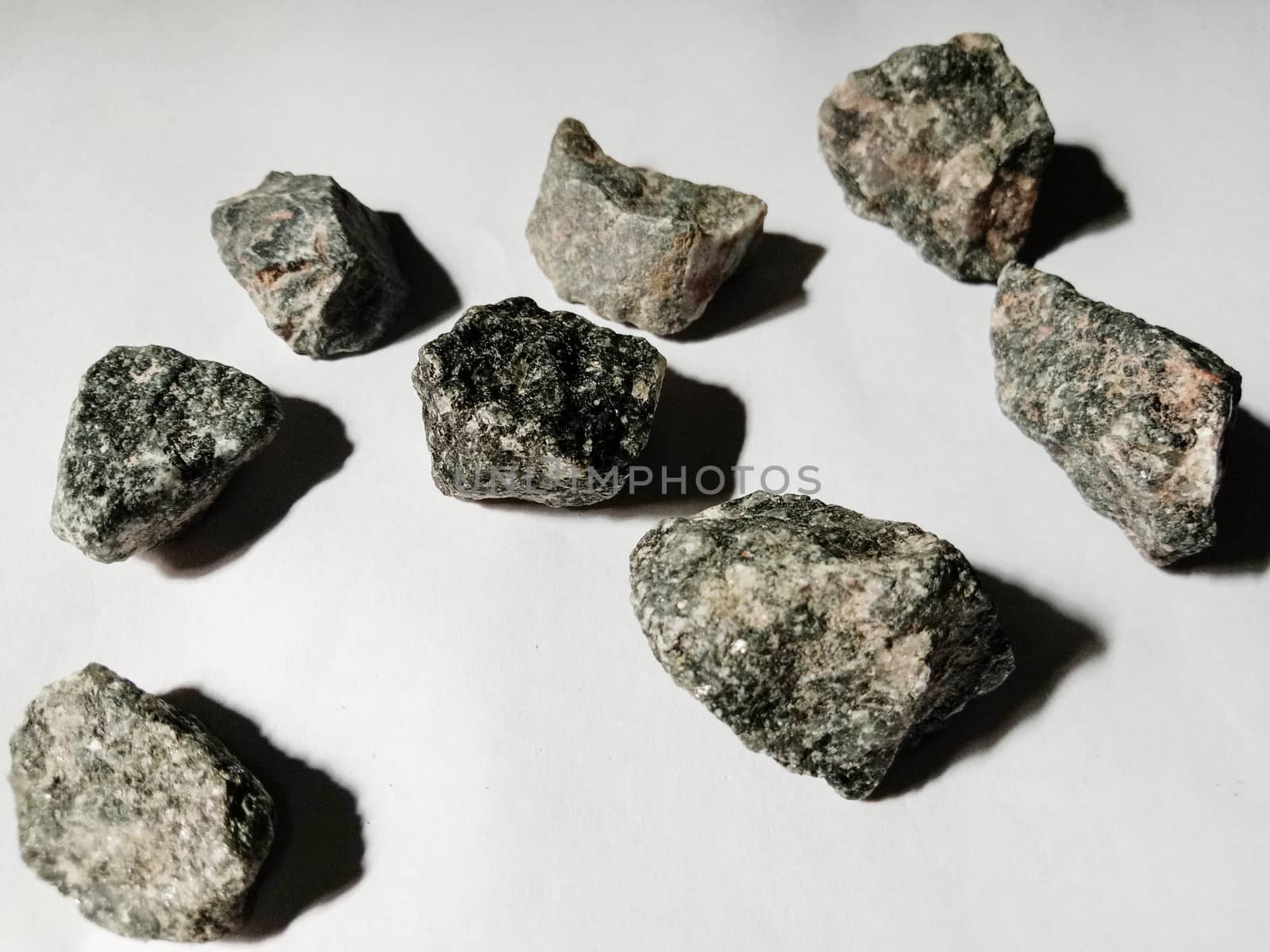 Black Colored Stone Stock on Pink Background