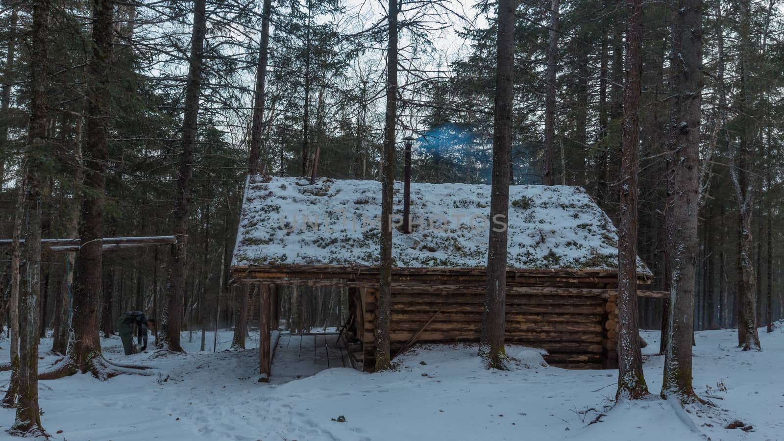 The pristine nature of the Zeya reserve. A wooden winter hut stands among the taiga