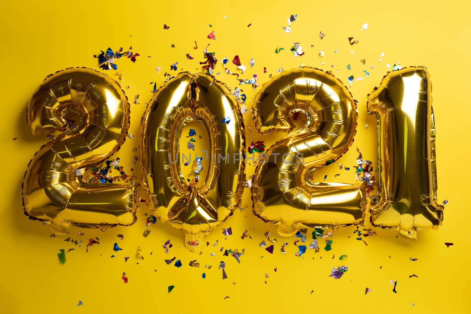 2021 new year concept from golden foil balloon and confetti by adamr