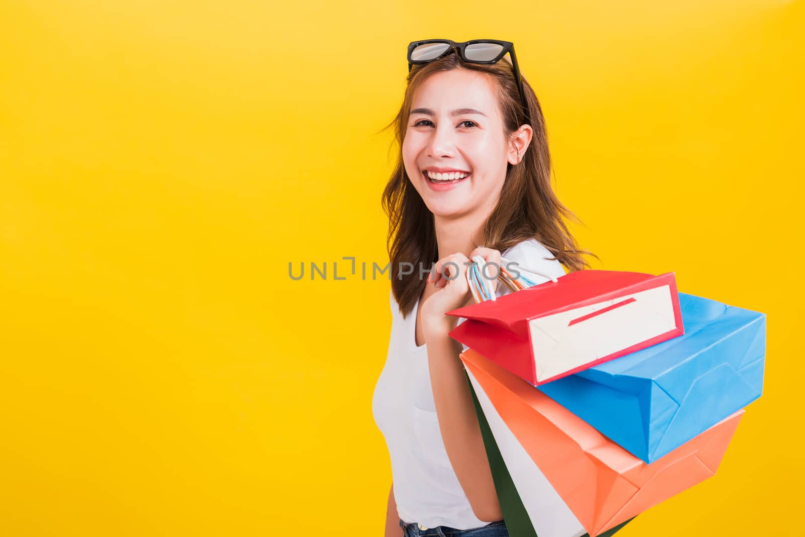 woman teen smiling standing with sunglasses excited holding shop by Sorapop