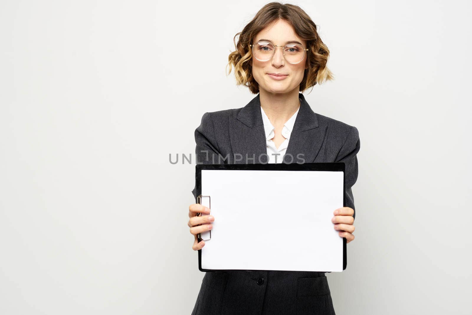 Business woman with a folder of documents on a light background cropped view and shirt suit. High quality photo