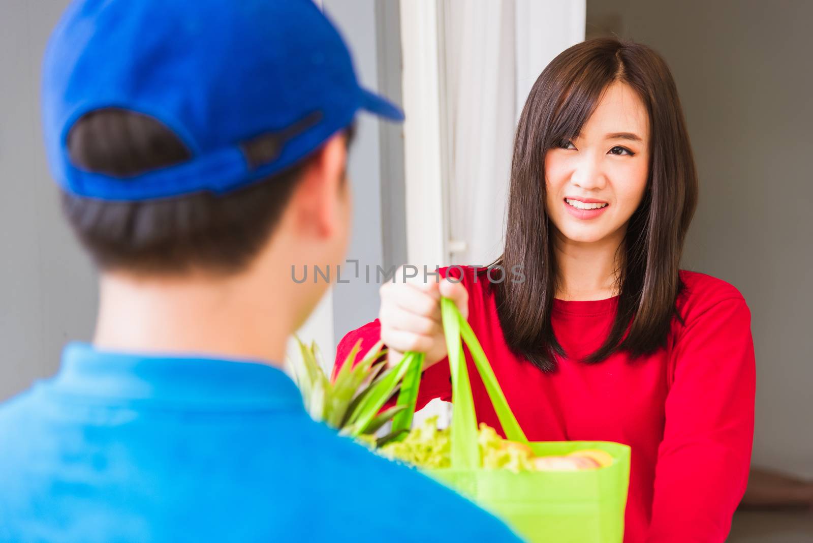 Delivery man making grocery service giving fresh vegetables and  by Sorapop