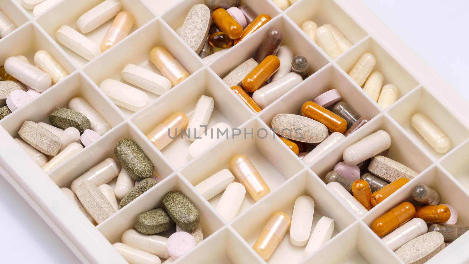 plastic medicine organizer with pills and capsules by happycreator