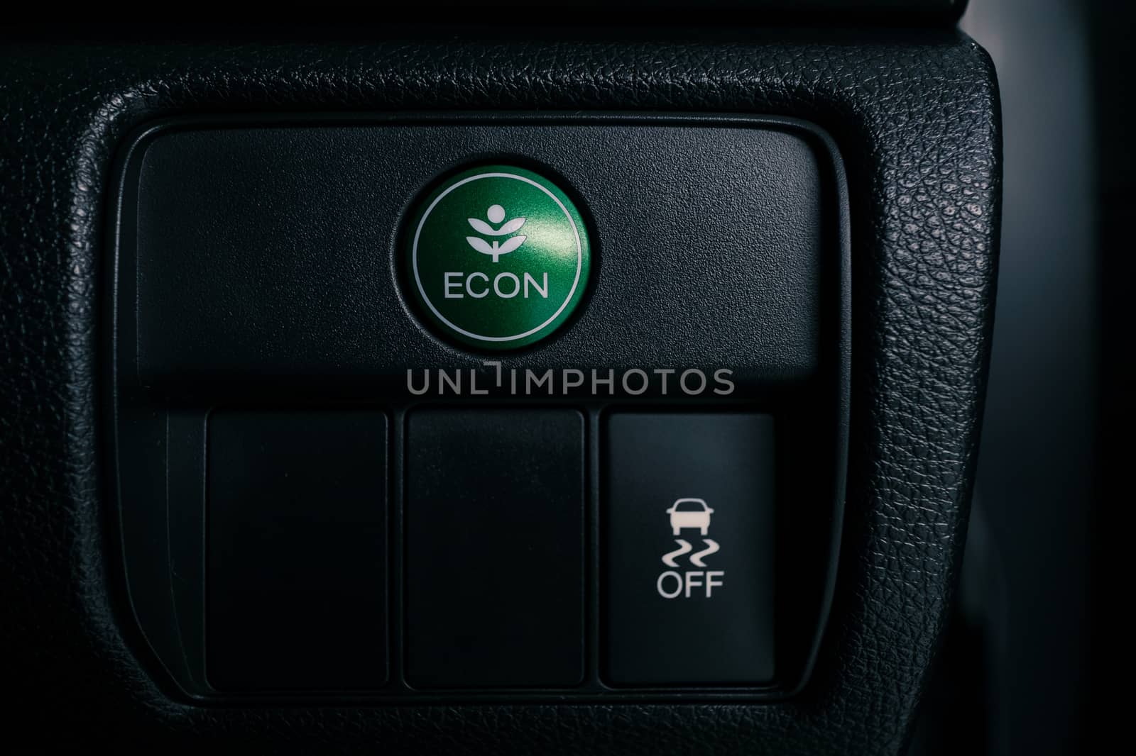 econ button on dashboard of modern car, press the button to switch to a setting that saves energy and to improving fuel efficiency, shallow depth of field