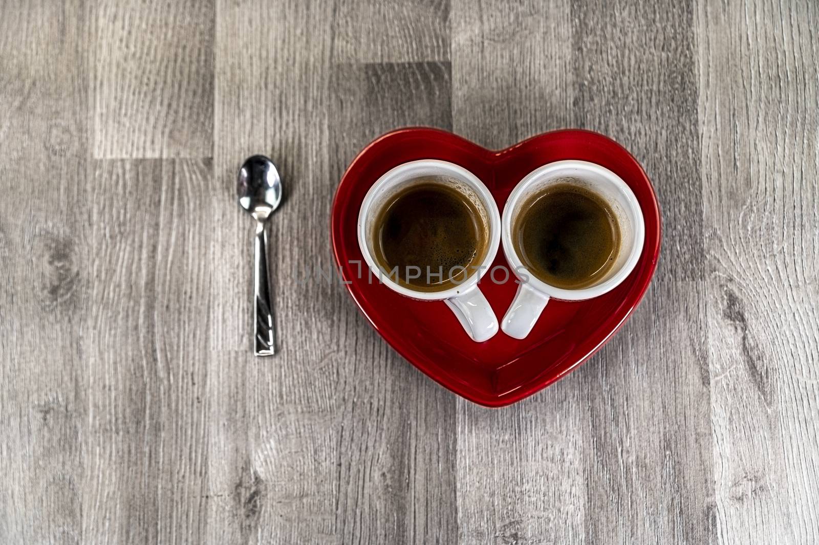 two teaspoons of coffee with a heart-shaped saucer and a teaspoon