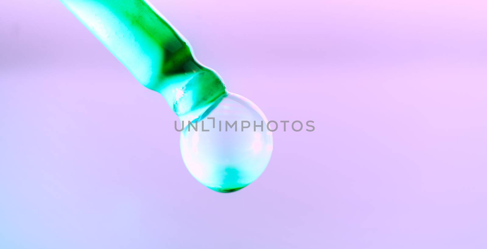 Color drop tube science and art experiment drop color into green template green concept background.