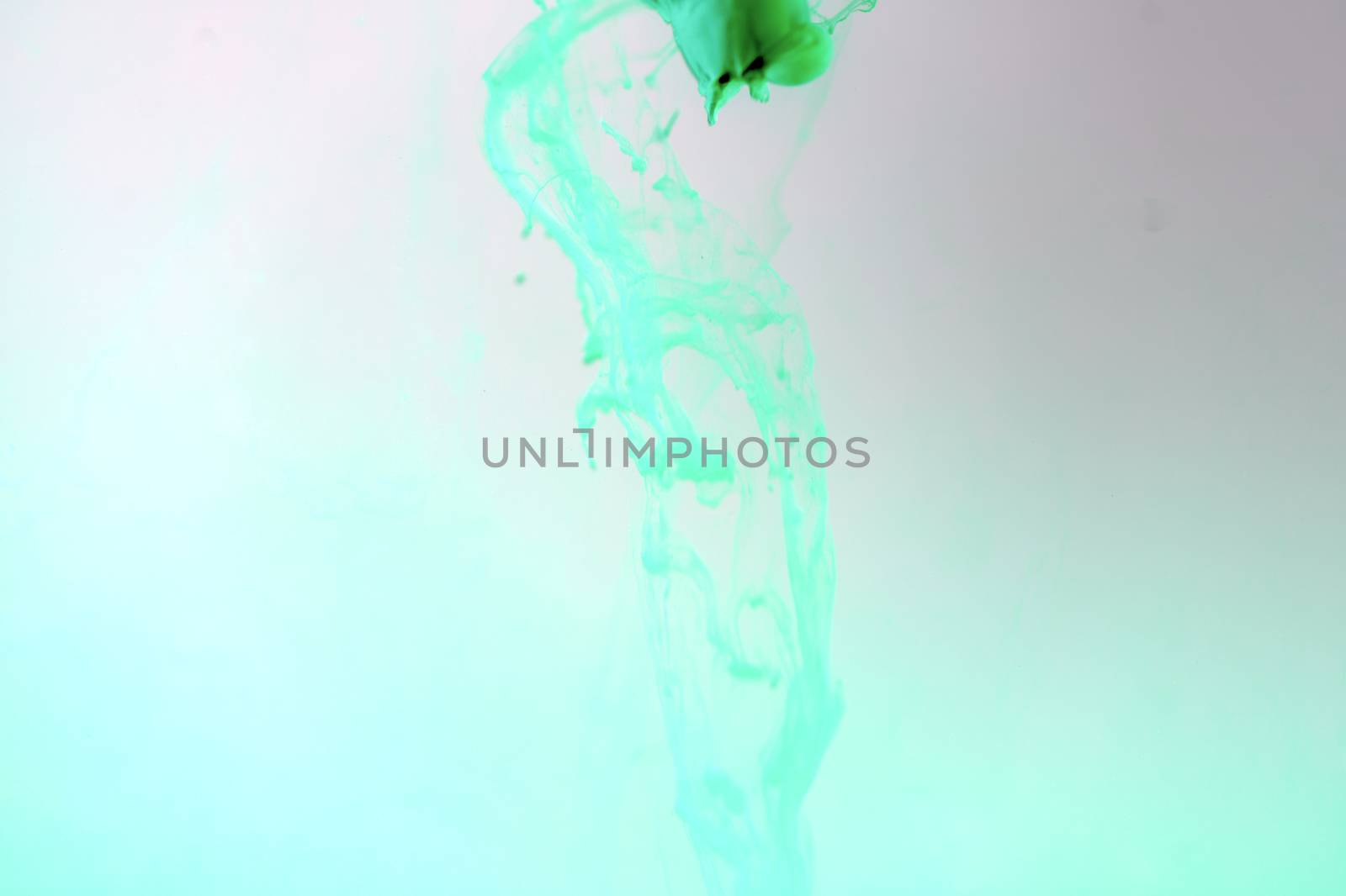 Color drop tube science and art experiment drop color into green template green concept background.