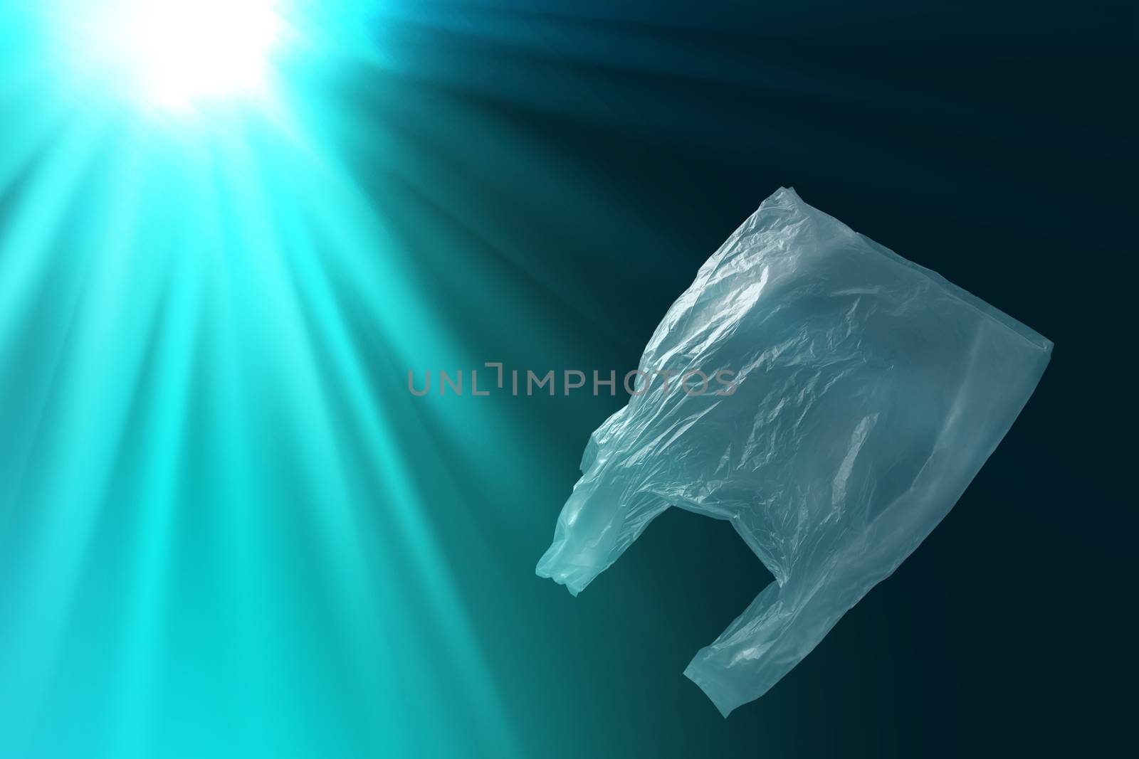 single-use plastic bag floating in sea or ocean by happycreator