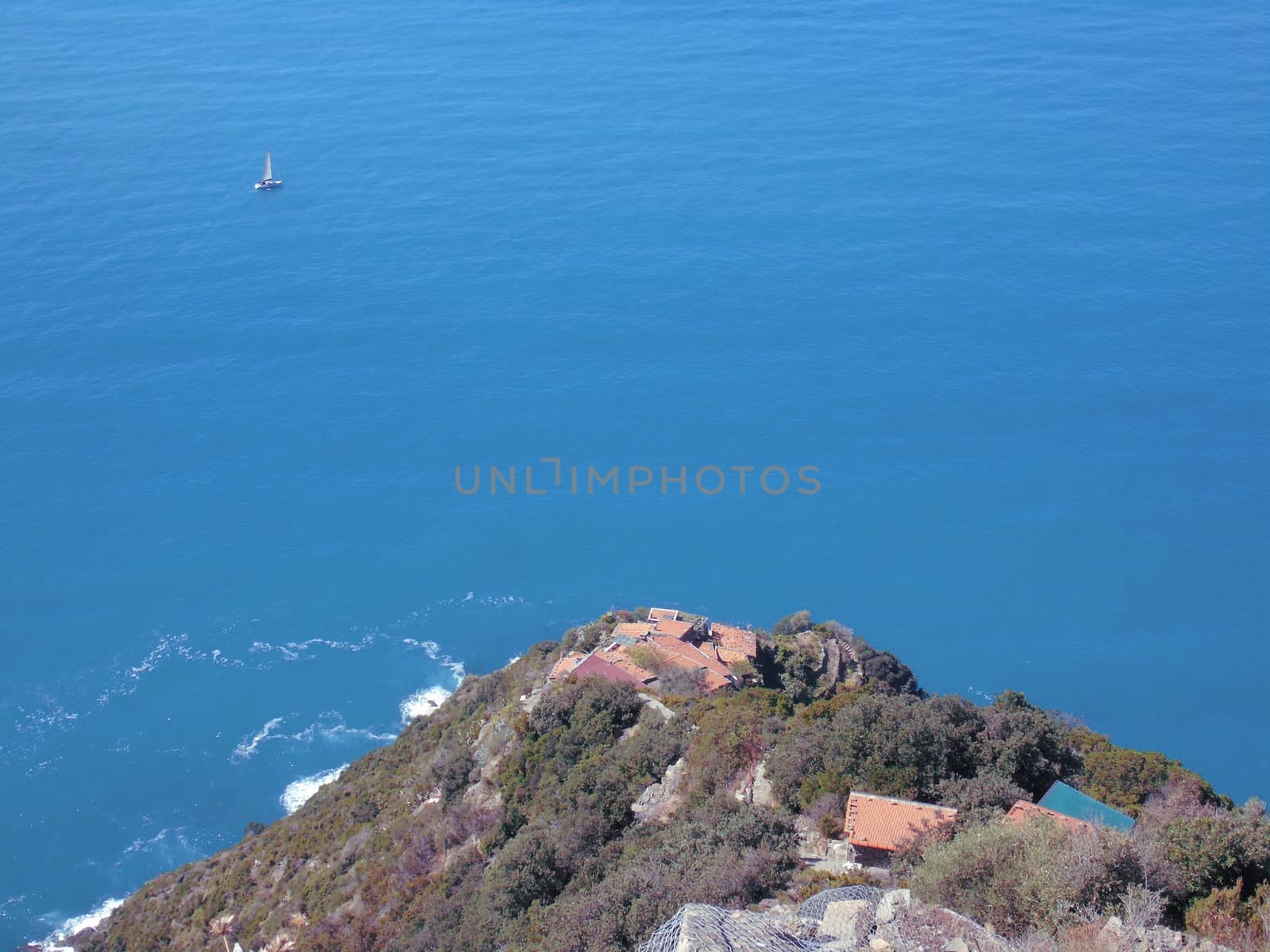 Liguria, Italy - 06/15/2020: Travelling around the ligurian seaside in summer days with beautiful view to the famous places. An amazing caption of the water and the sky reflection with blue sky.