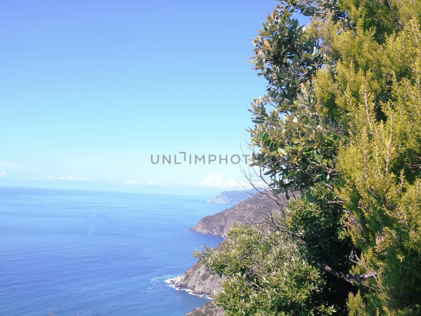 Liguria, Italy - 06/15/2020: Travelling around the ligurian seaside in summer days with beautiful view to the famous places. An amazing caption of the water and the sky reflection with blue sky.