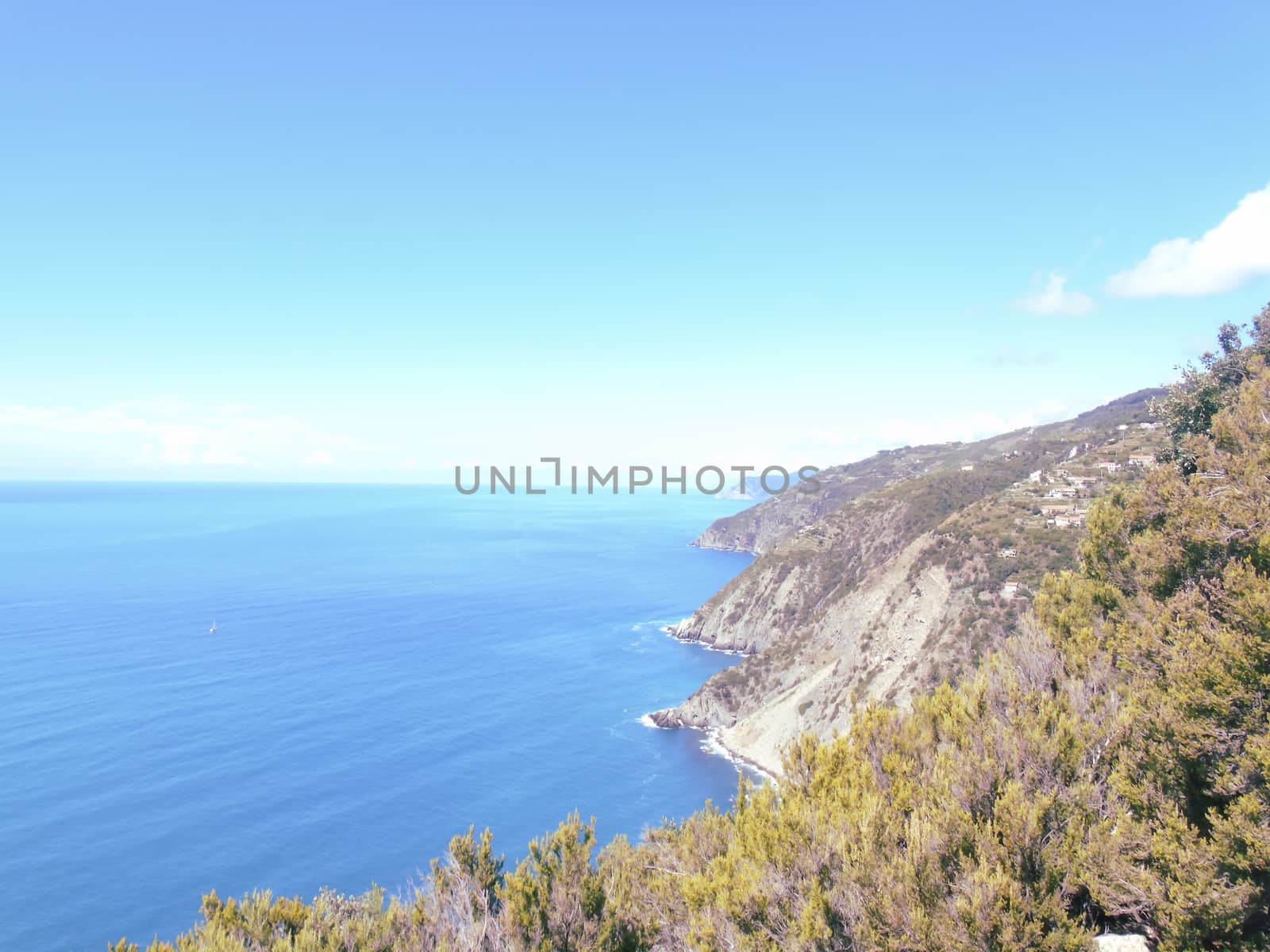 Liguria, Italy - 06/15/2020: Travelling around the ligurian seaside in summer days with beautiful view to the famous places. An amazing caption of the water and the sky reflection with blue sky.