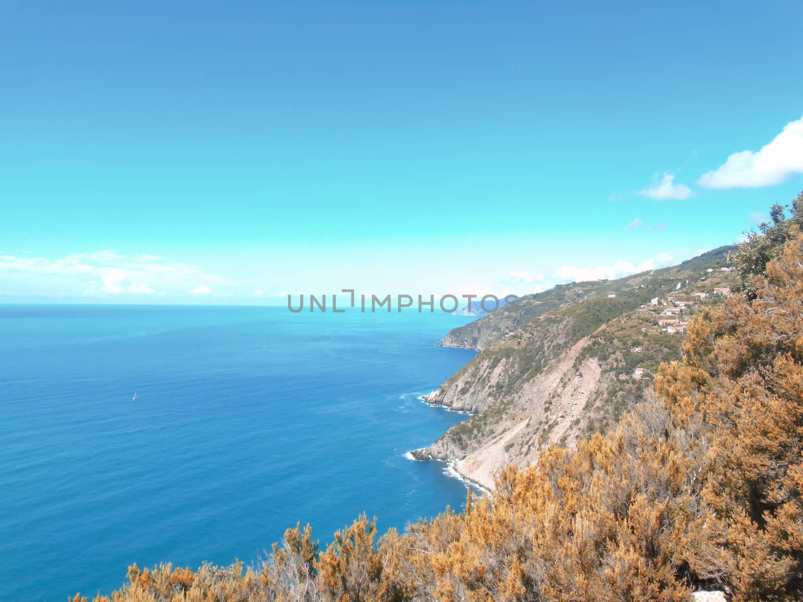 Liguria, Italy - 06/15/2020: Travelling around the ligurian seaside in summer days with beautiful view to the famous places. An amazing caption of the water and the sky reflection with blue sky.