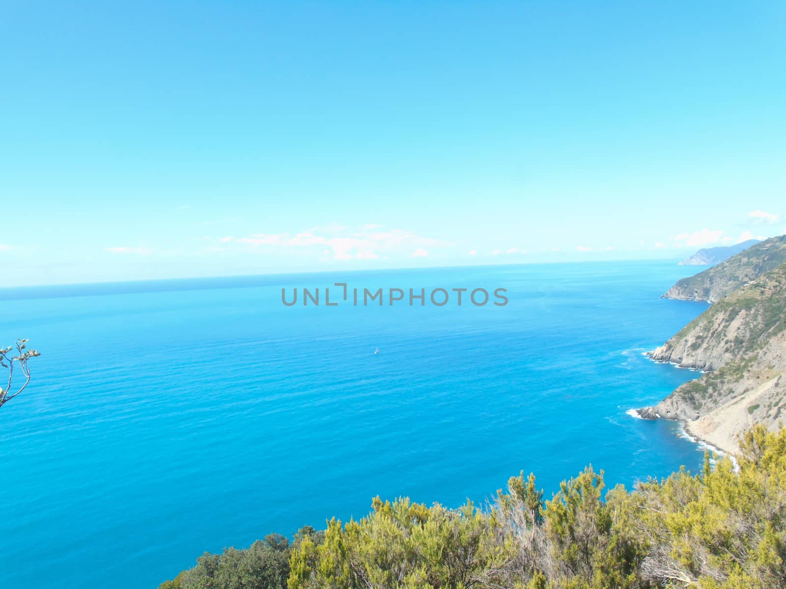 Liguria, Italy - 06/15/2020: Travelling around the ligurian seaside in summer days with beautiful view to the famous places. An amazing caption of the water and the sky reflection with blue sky.