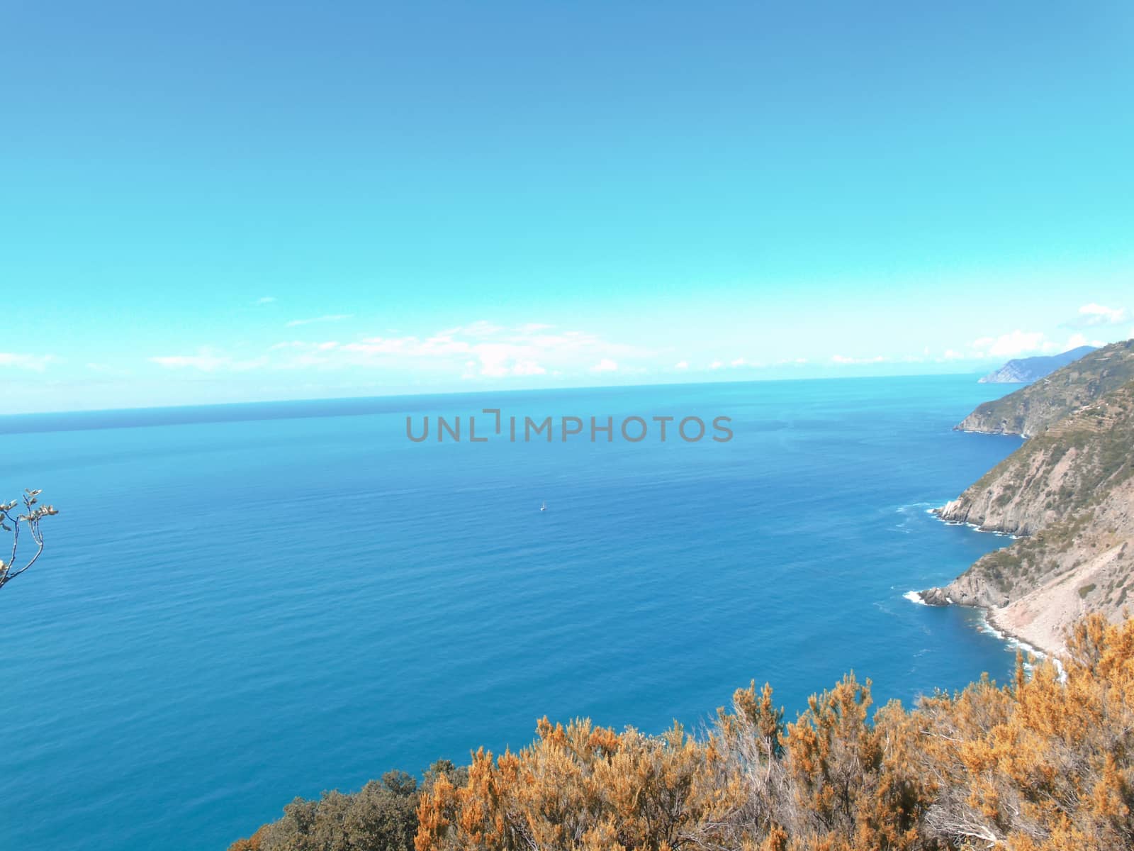 Liguria, Italy - 06/15/2020: Travelling around the ligurian seaside in summer days with beautiful view to the famous places. An amazing caption of the water and the sky reflection with blue sky.