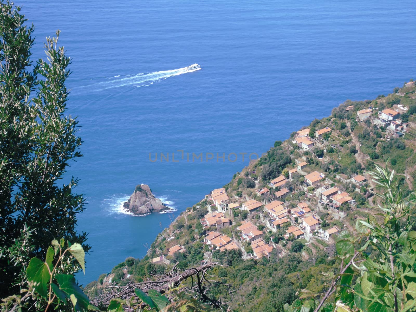 Liguria, Italy - 06/15/2020: Travelling around the ligurian seaside in summer days with beautiful view to the famous places. An amazing caption of the water and the sky reflection with blue sky.