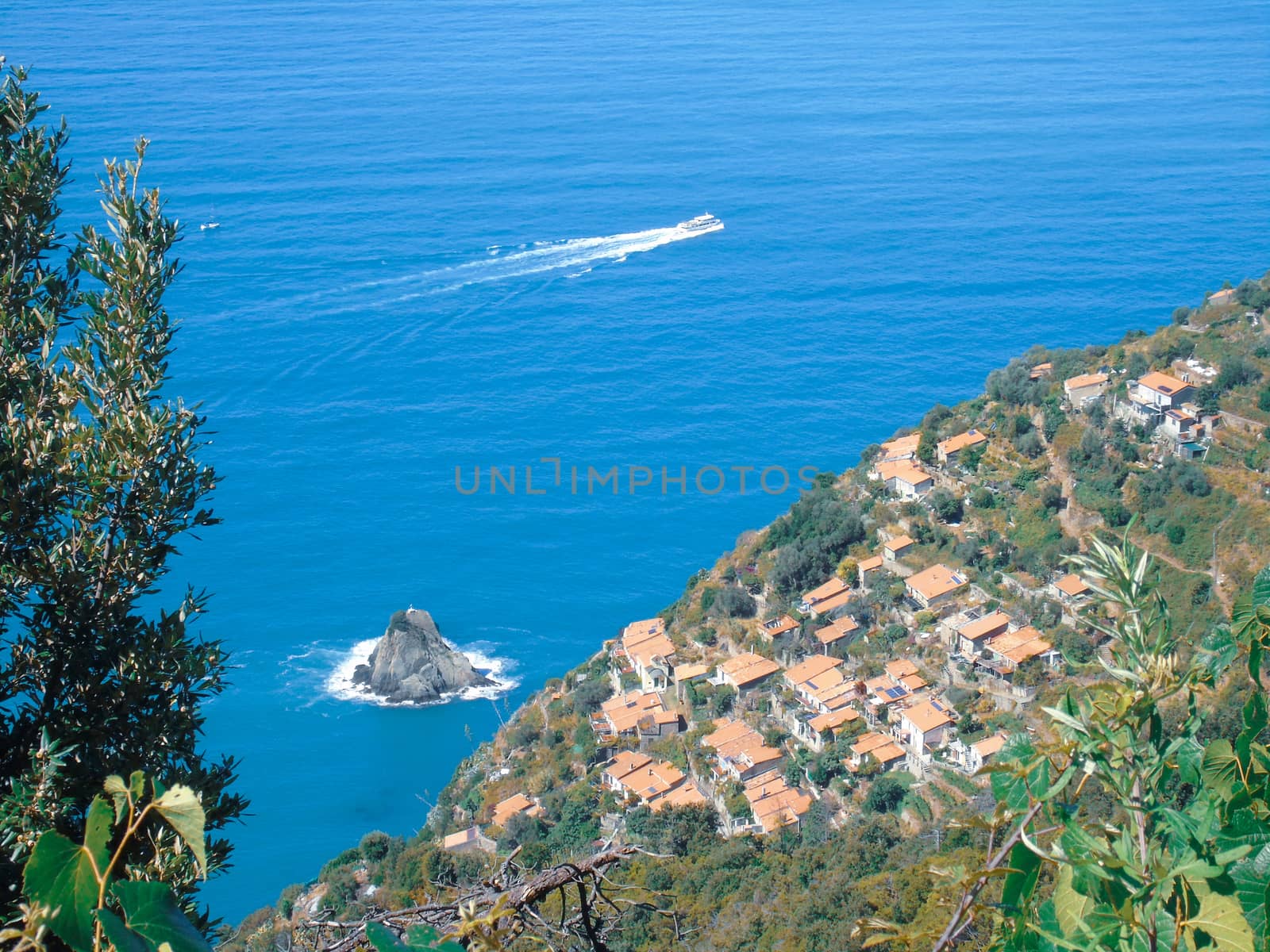 Liguria, Italy - 06/15/2020: Travelling around the ligurian seaside in summer days with beautiful view to the famous places. An amazing caption of the water and the sky reflection with blue sky.