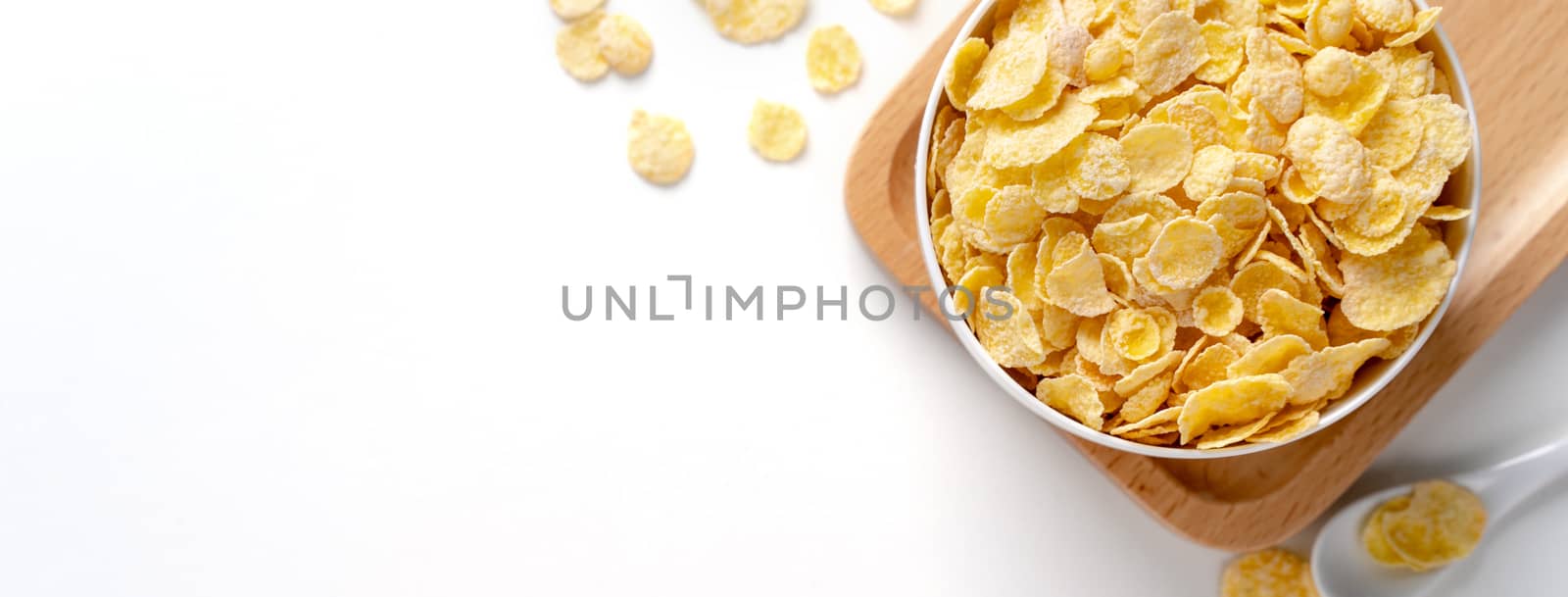 Top view of corn flakes bowl sweeties with milk and orange on white background, flat lay overhead layout, fresh and healthy breakfast design concept.