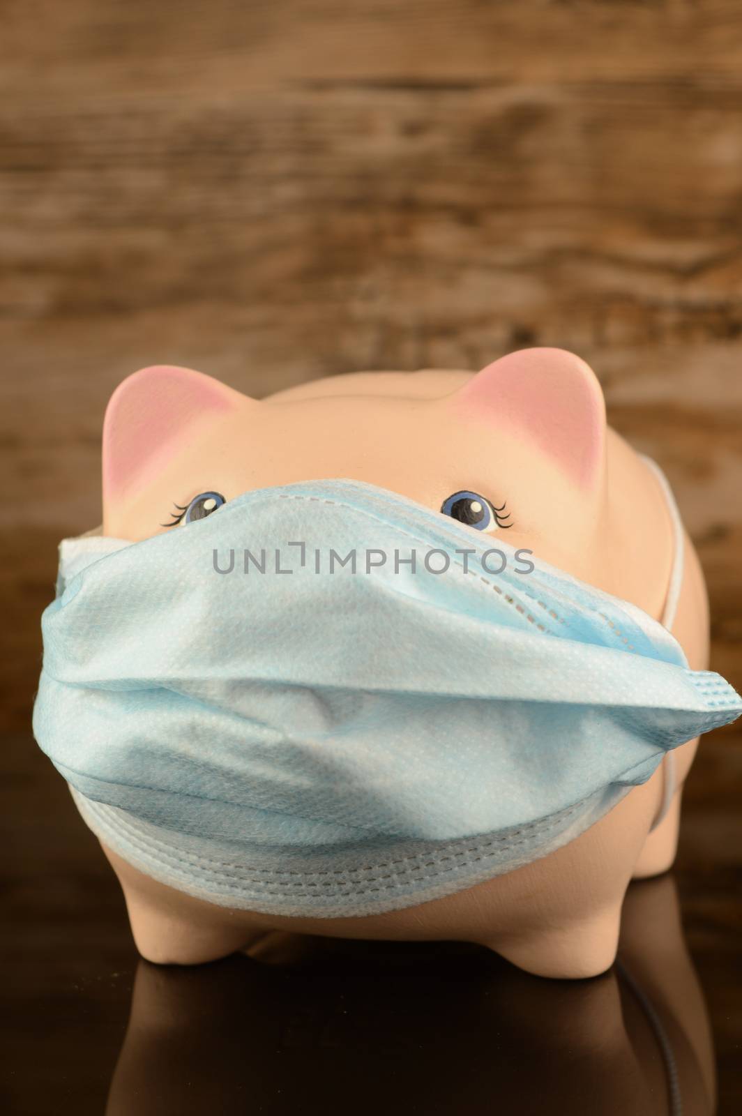 A masked piggy bank for financial crisis concepts related to the covid coronavirus pandemic.