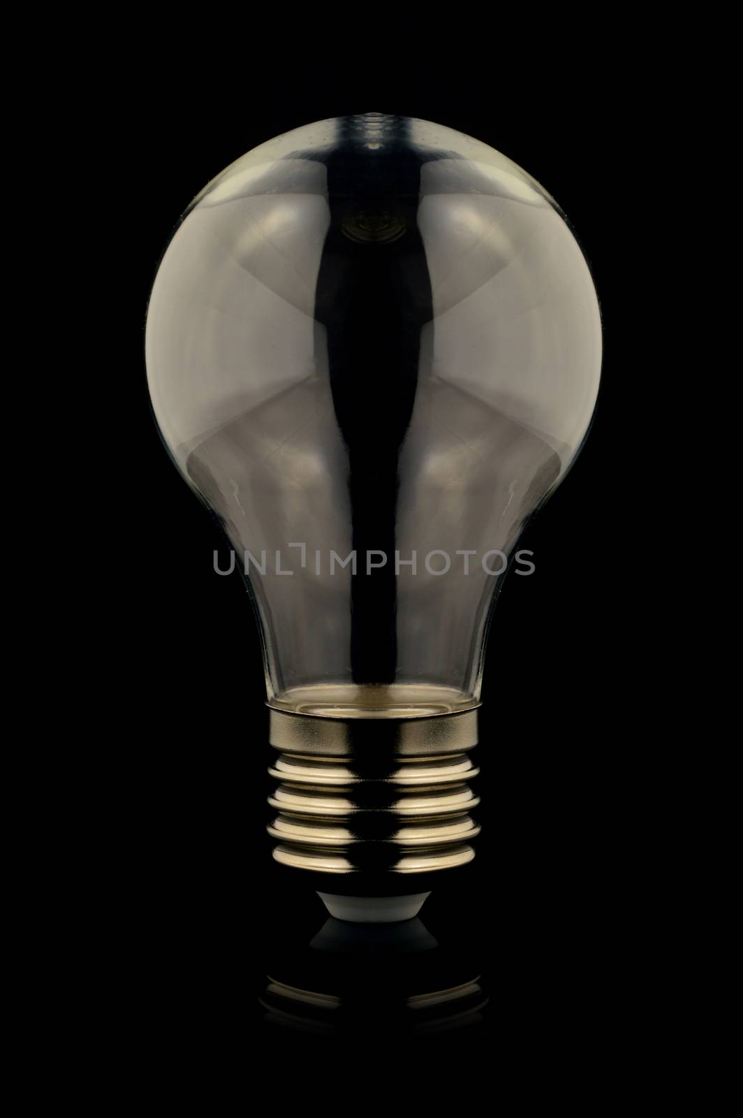 An isolated over black reflective surface image of a lightbulb with an empty inside which is good for graphic design insert composites.