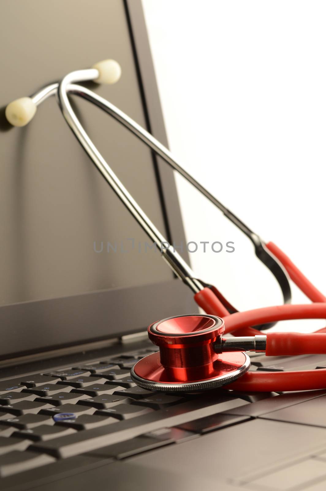 A stethoscope on a laptop for online healthcare services.