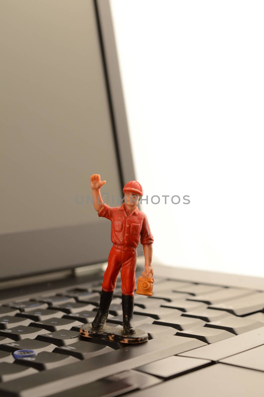 A little man waves from on the laptop.