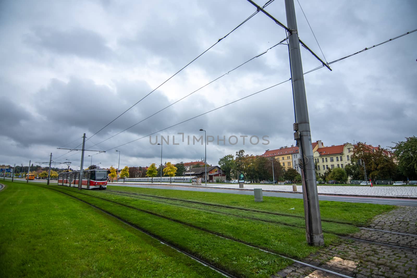 Tram after crossing Hradcanska in Prague cloudy day by gonzalobell