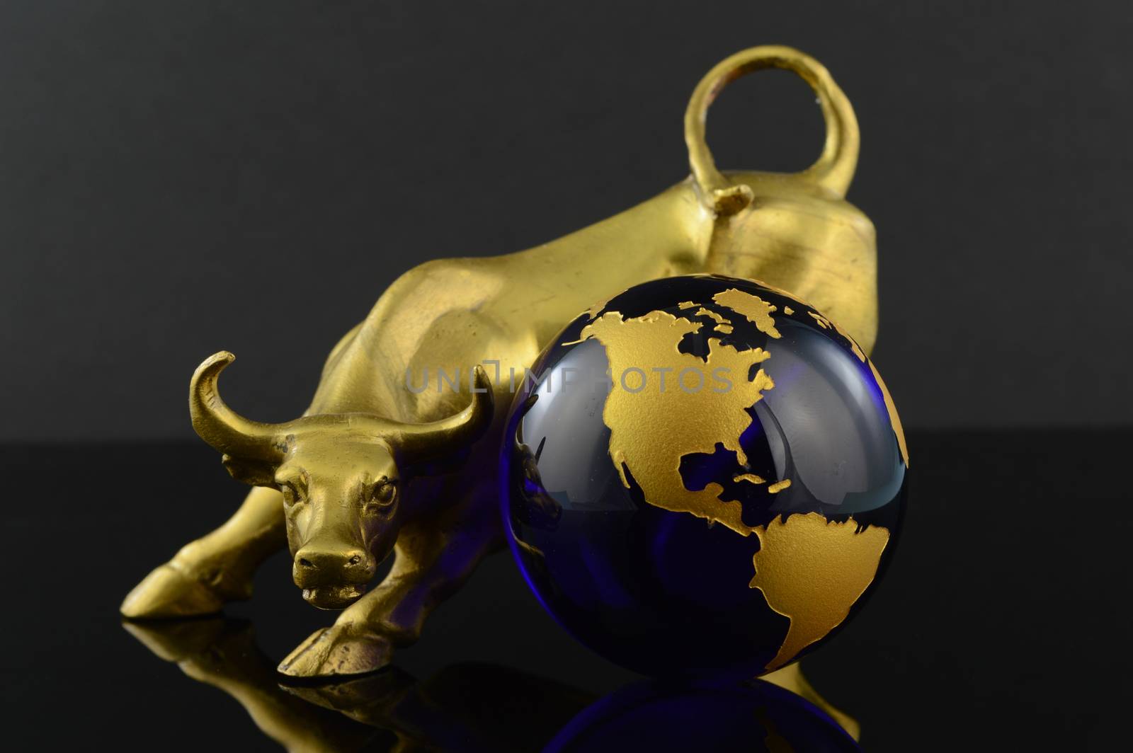 A golden bull and globe for aggresive world market trends.