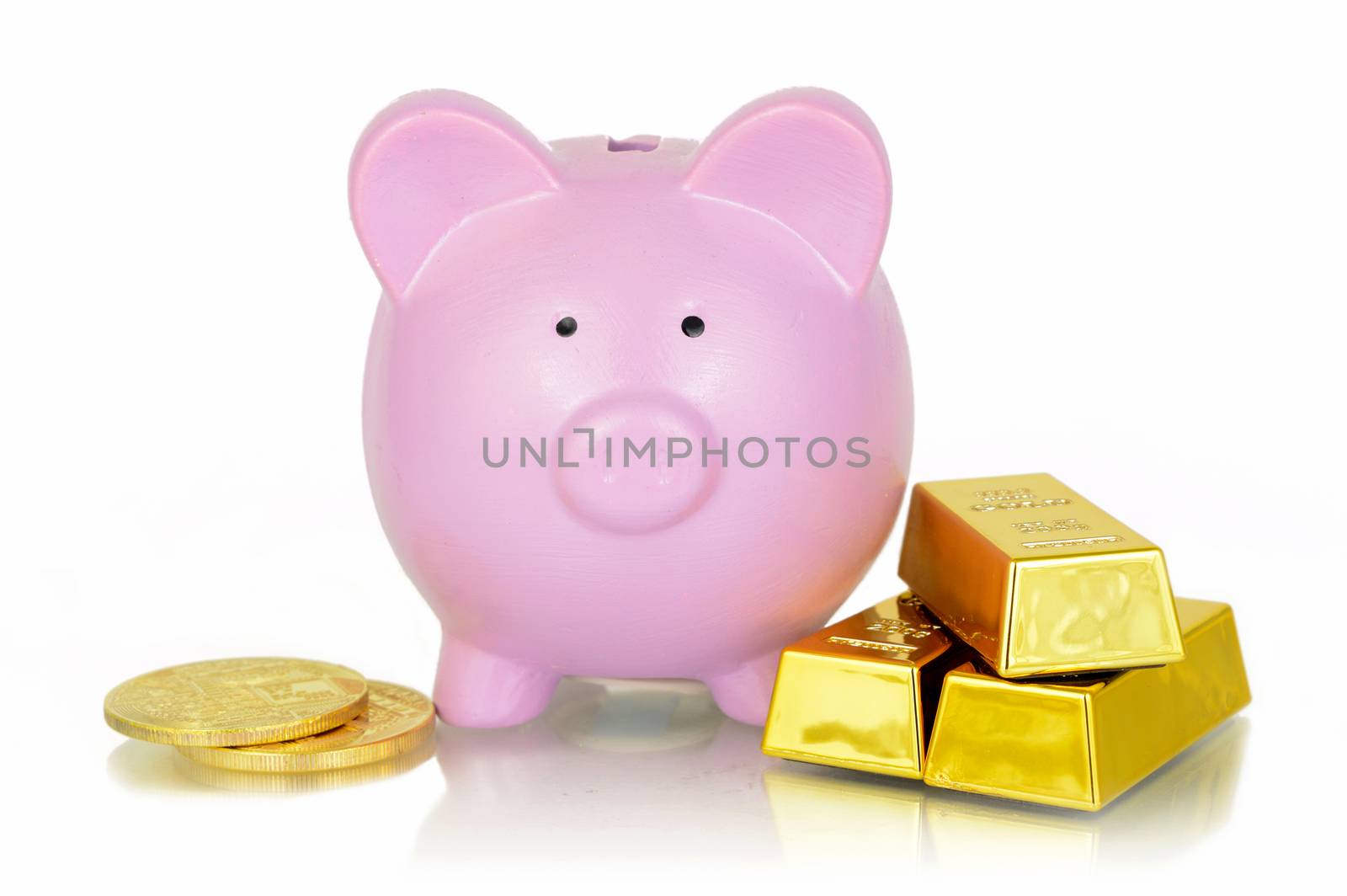 A concept of banking with gold using a pink piggy bank and bullion bars and coins.