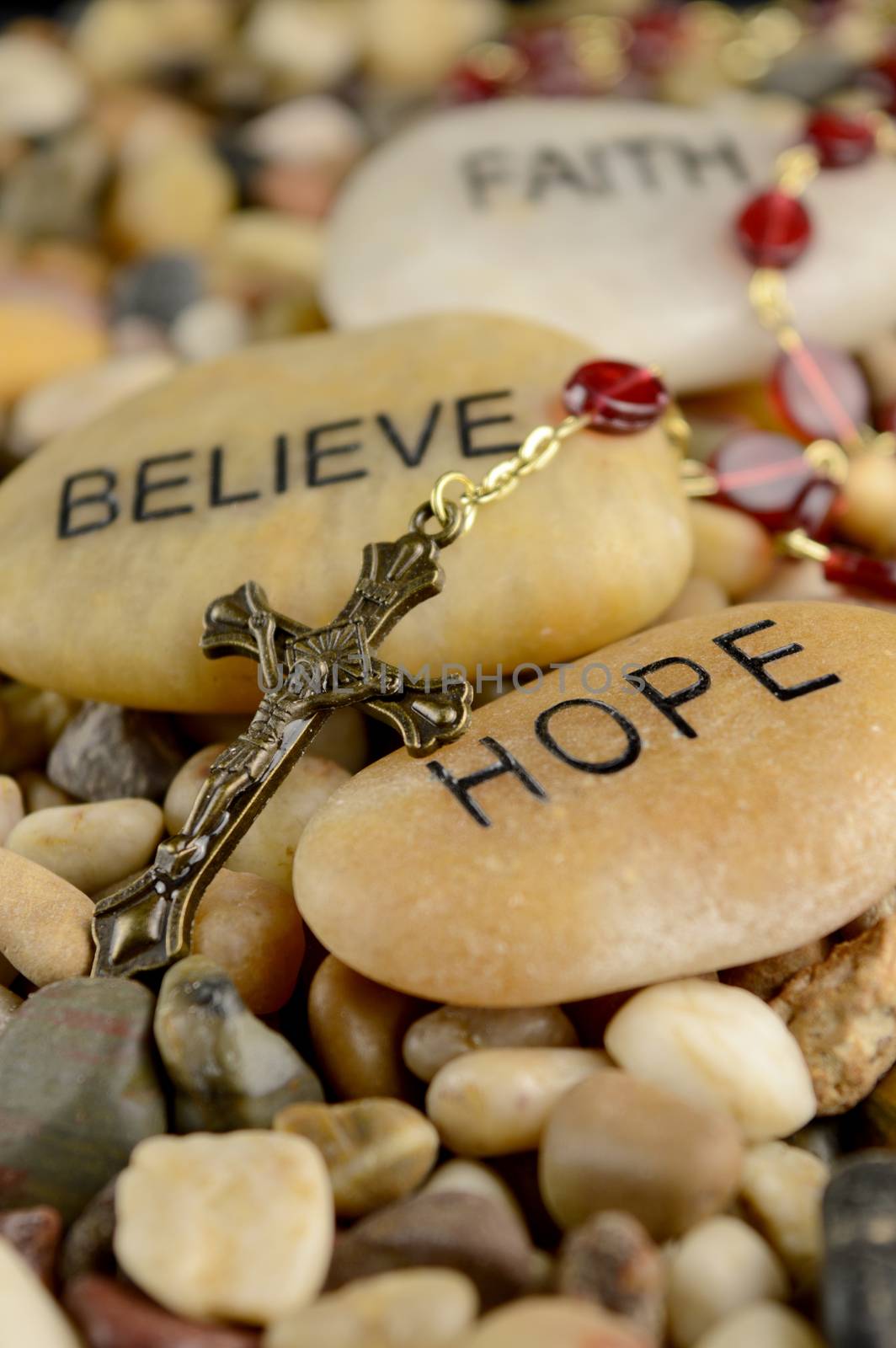 Worded stones with a Rosary to bring meaning to the faith of Jesus Christ.