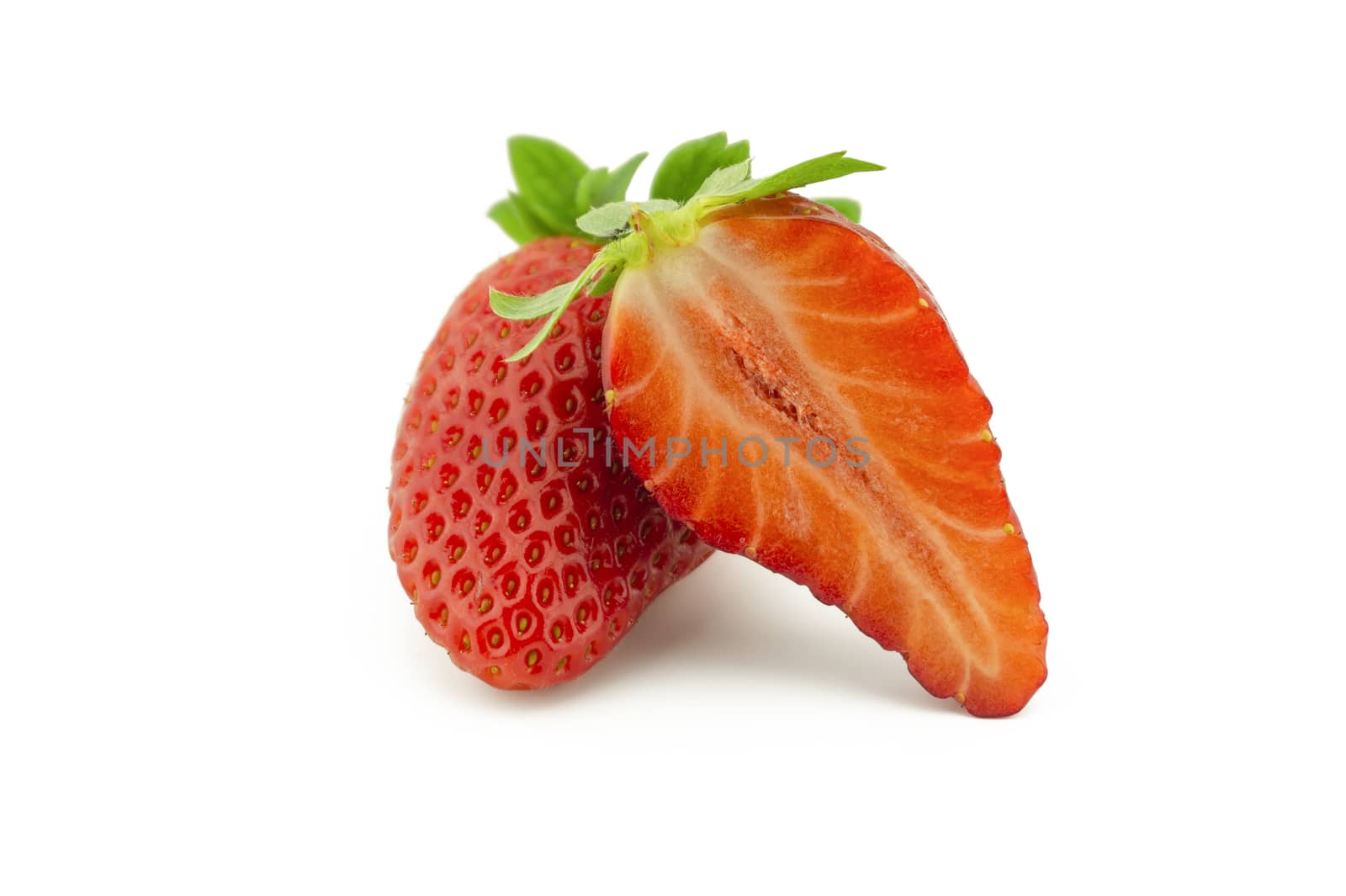 Whole strawberry fruit and half isolated on white background