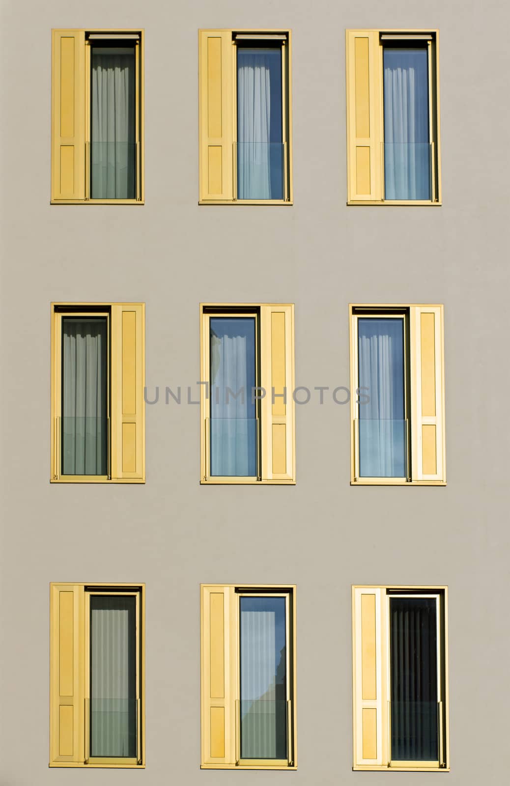 A hotel facade with golden window shutters