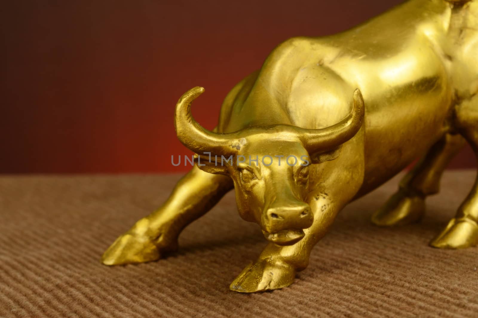 A closeup focus on a brass bull in a striking pose for many powerful concepts.