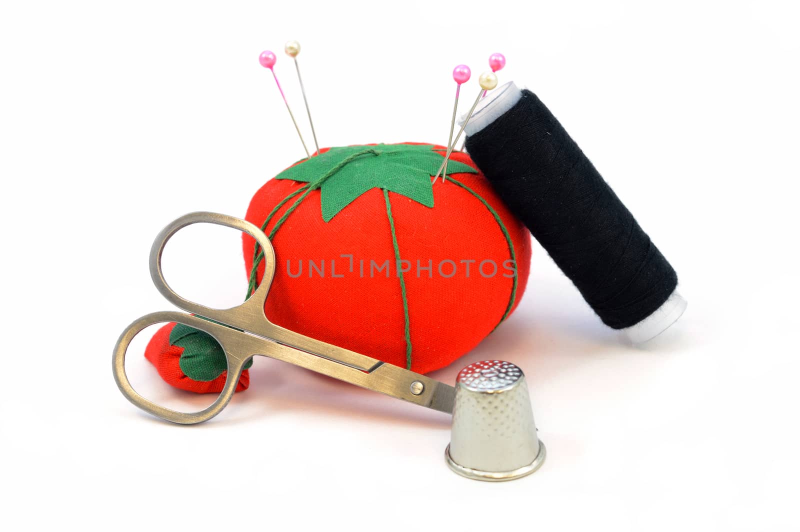An isolated set of sewing items over a white background.