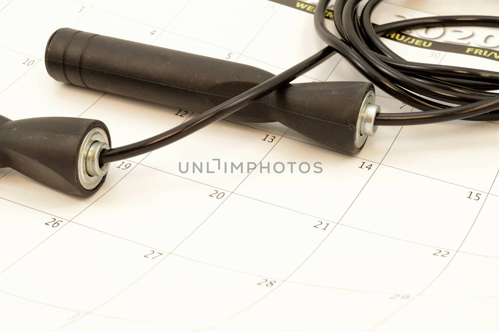 A skipping rope and calender represent a gym routine.