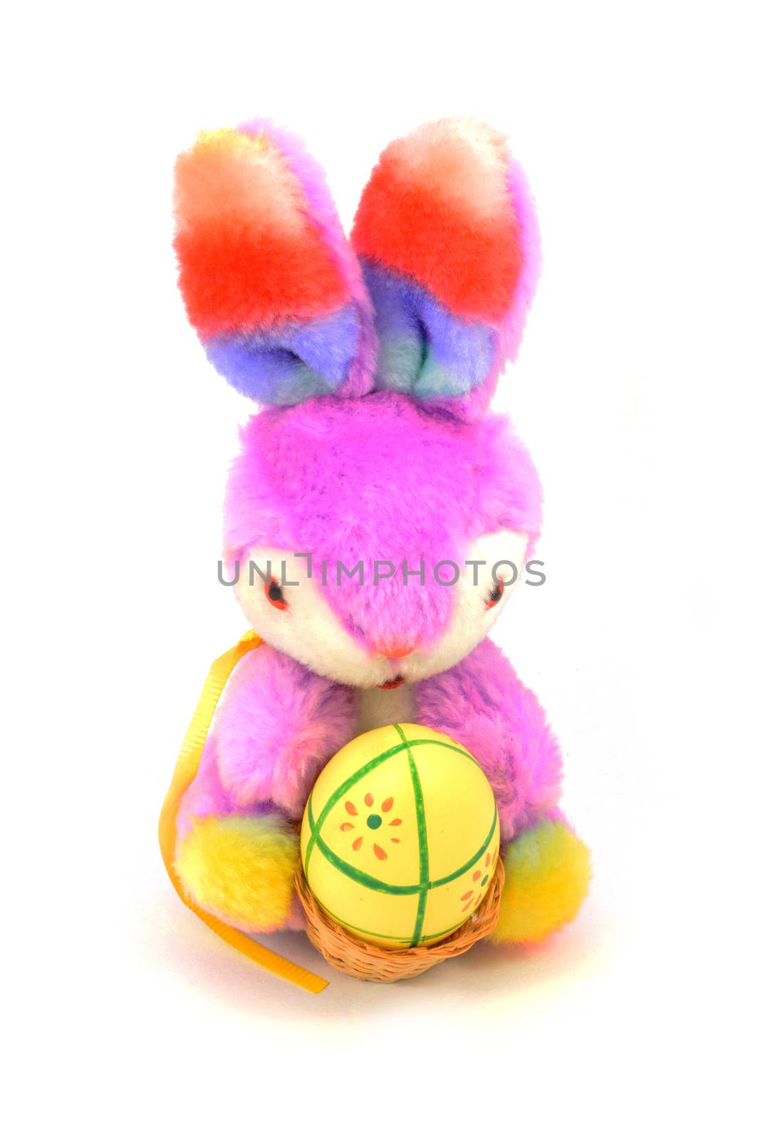 An isolated over white image of a plush Easter bunny with a painted egg for the holiday season.