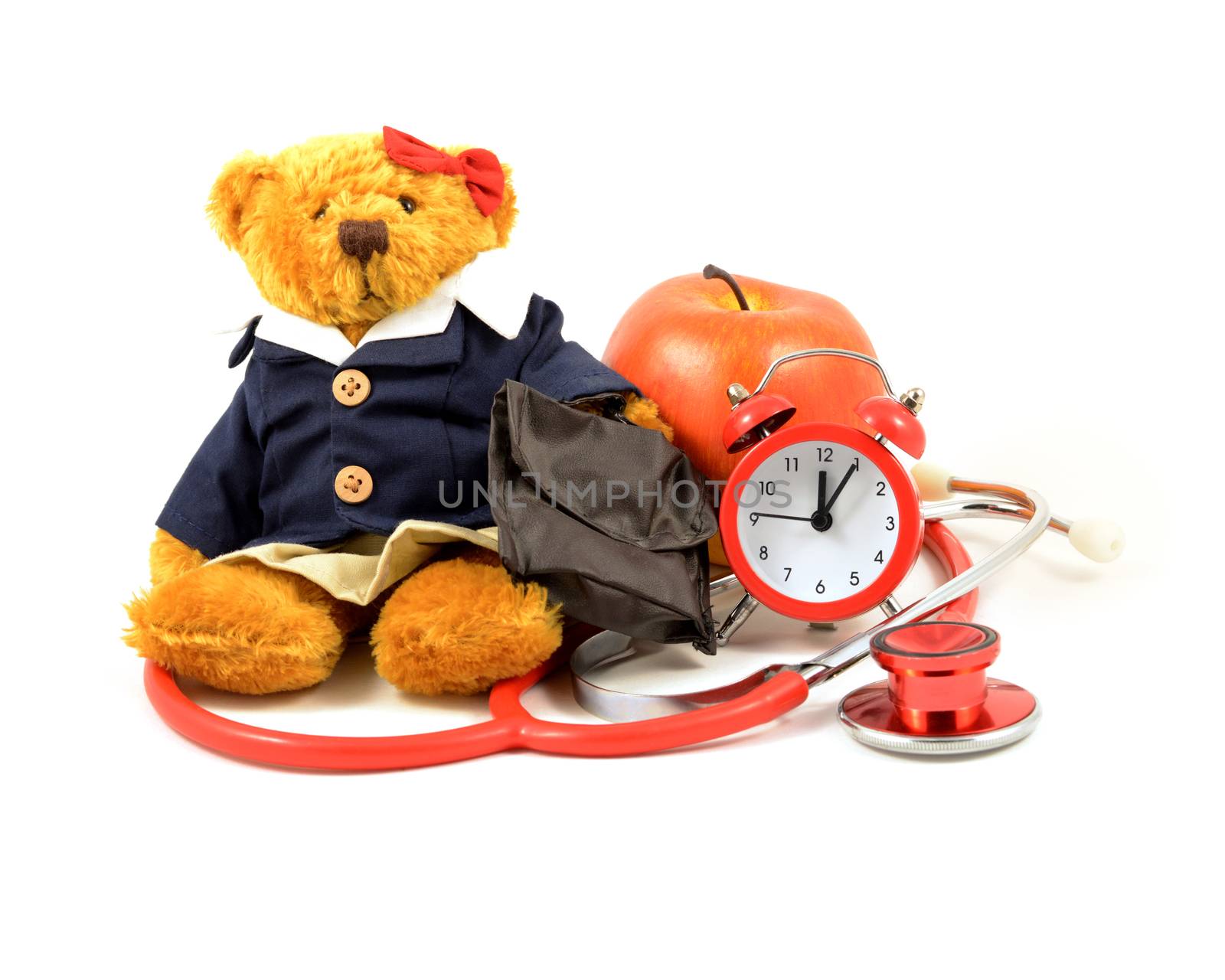 Time for a medical checkup concept utilizing a teddy bear with a clock and stethoscope isolated over a white background.