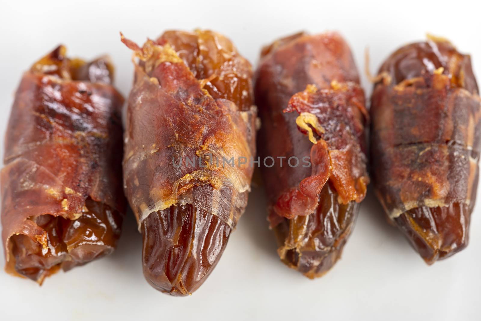 spanish dates with ham on a plate by bernjuer