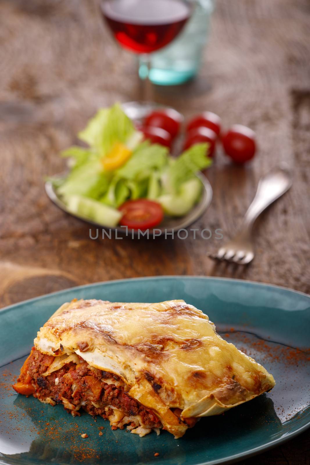 portion of italian lasagna on a blue plate