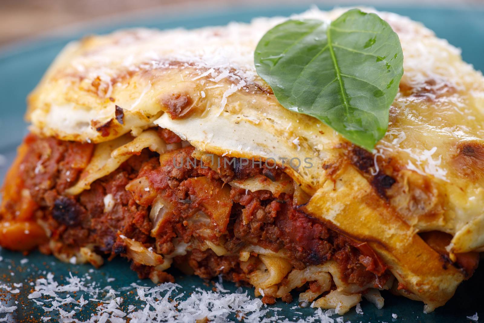 portion of italian lasagna on a blue plate