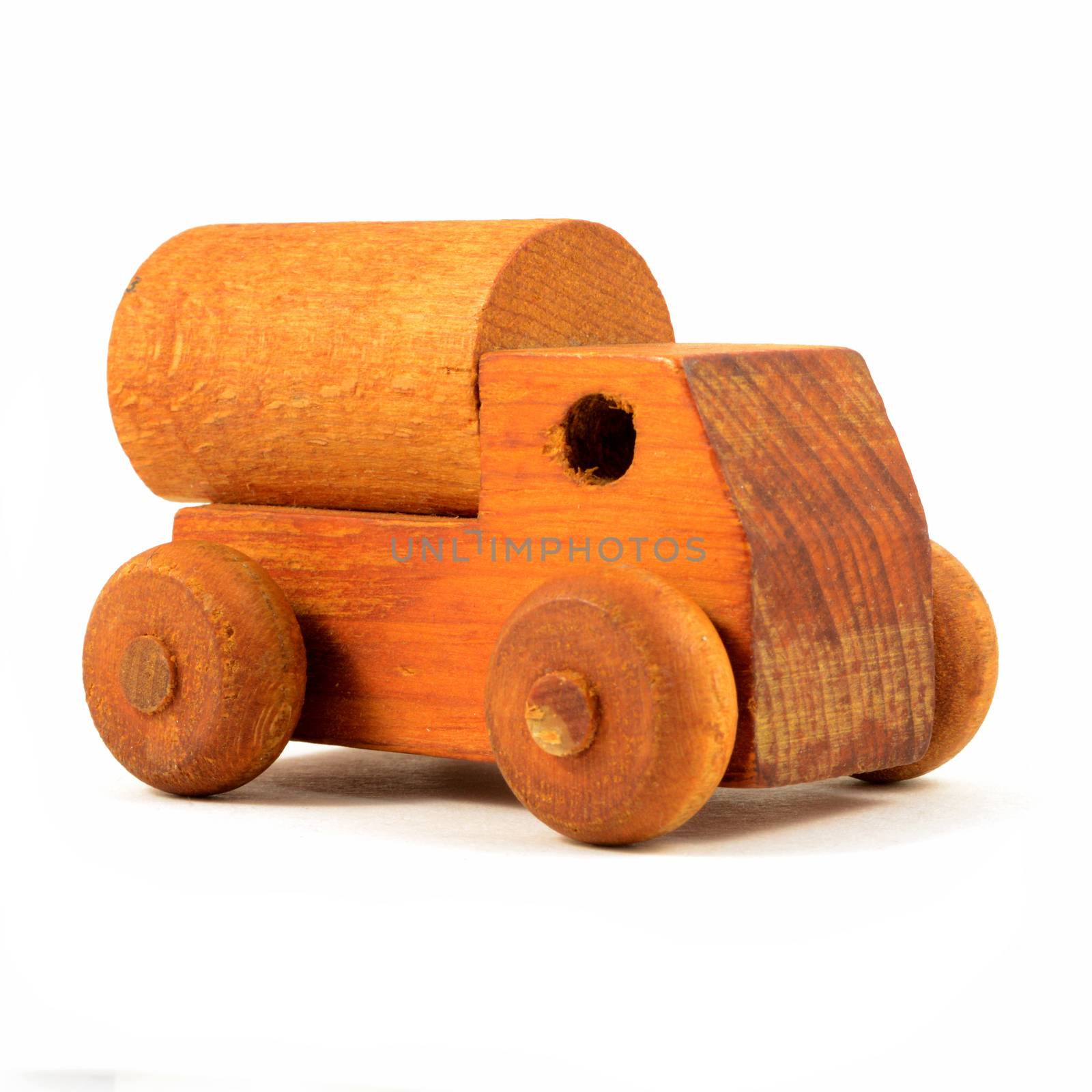 An isolated over a white background front view of a wood toy truck.