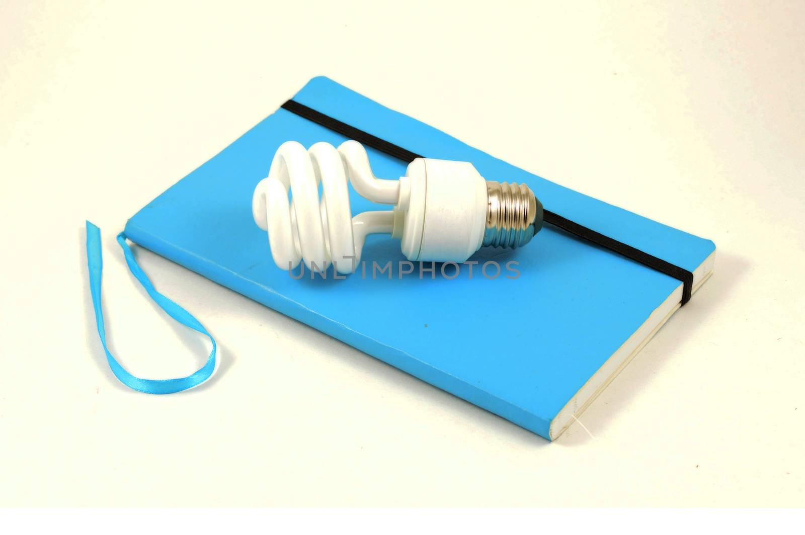 An isolated notebook and lightbulb to simulate ideas.