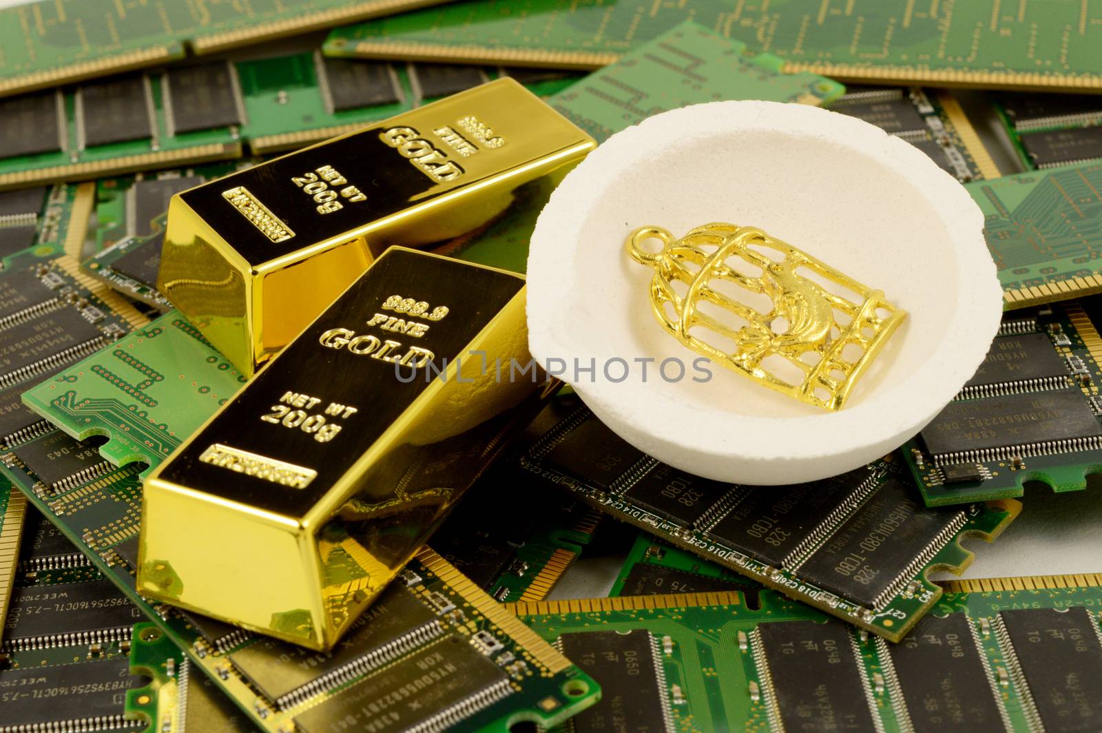 A closeup of Gold Refining items of digital scrap RAM and gold bullion and a smelting crucible.