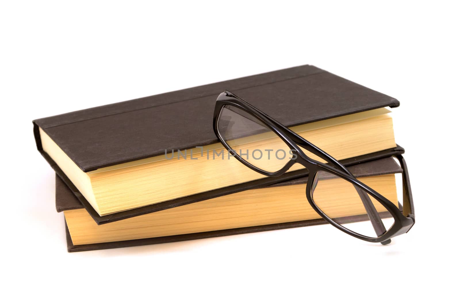 An isolated set of books and a pair of reading glasses for the viewer to see the pages come to life.