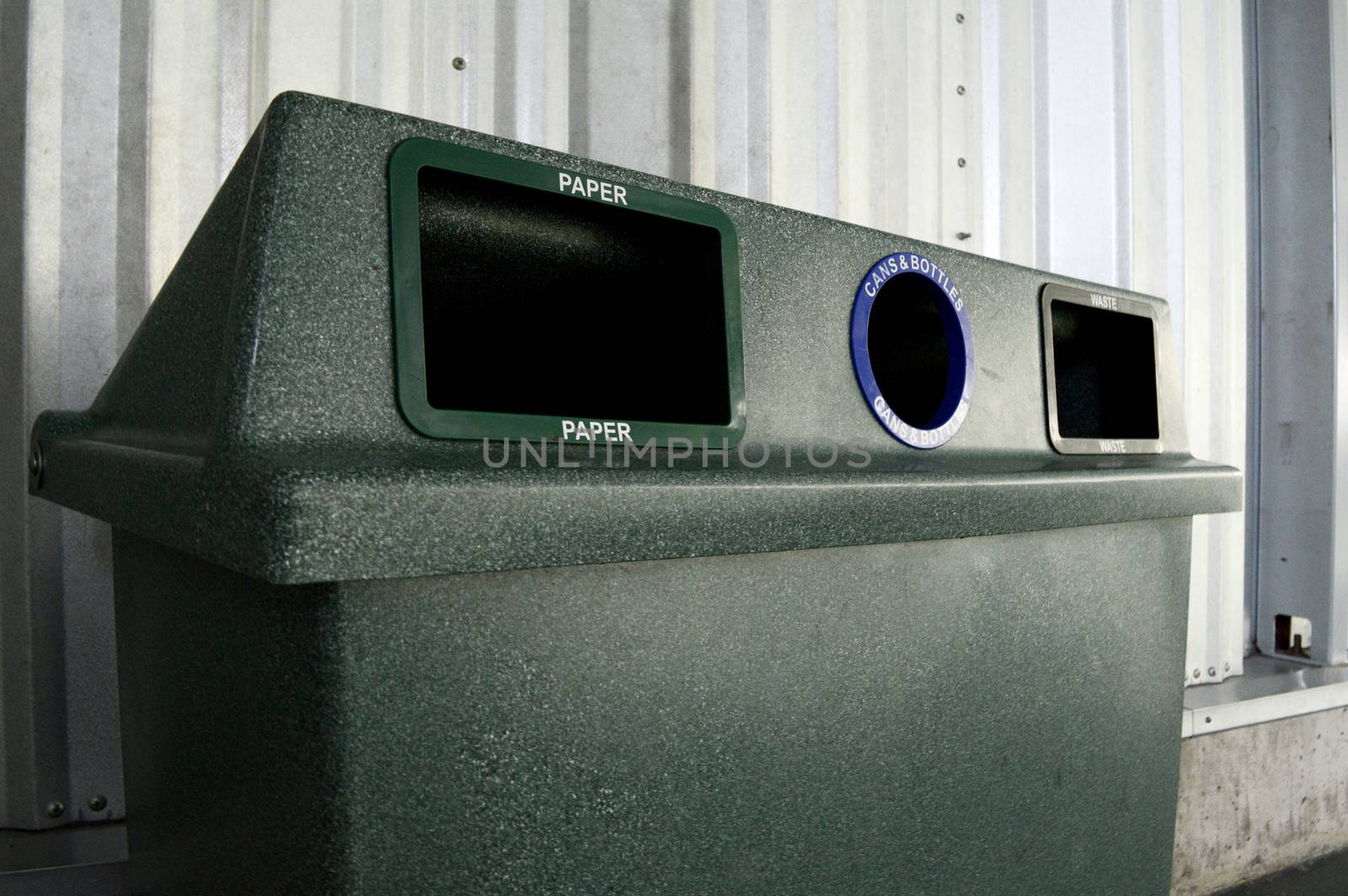 Closeup image of a modern recycle waste system for public usage at a local community centre.