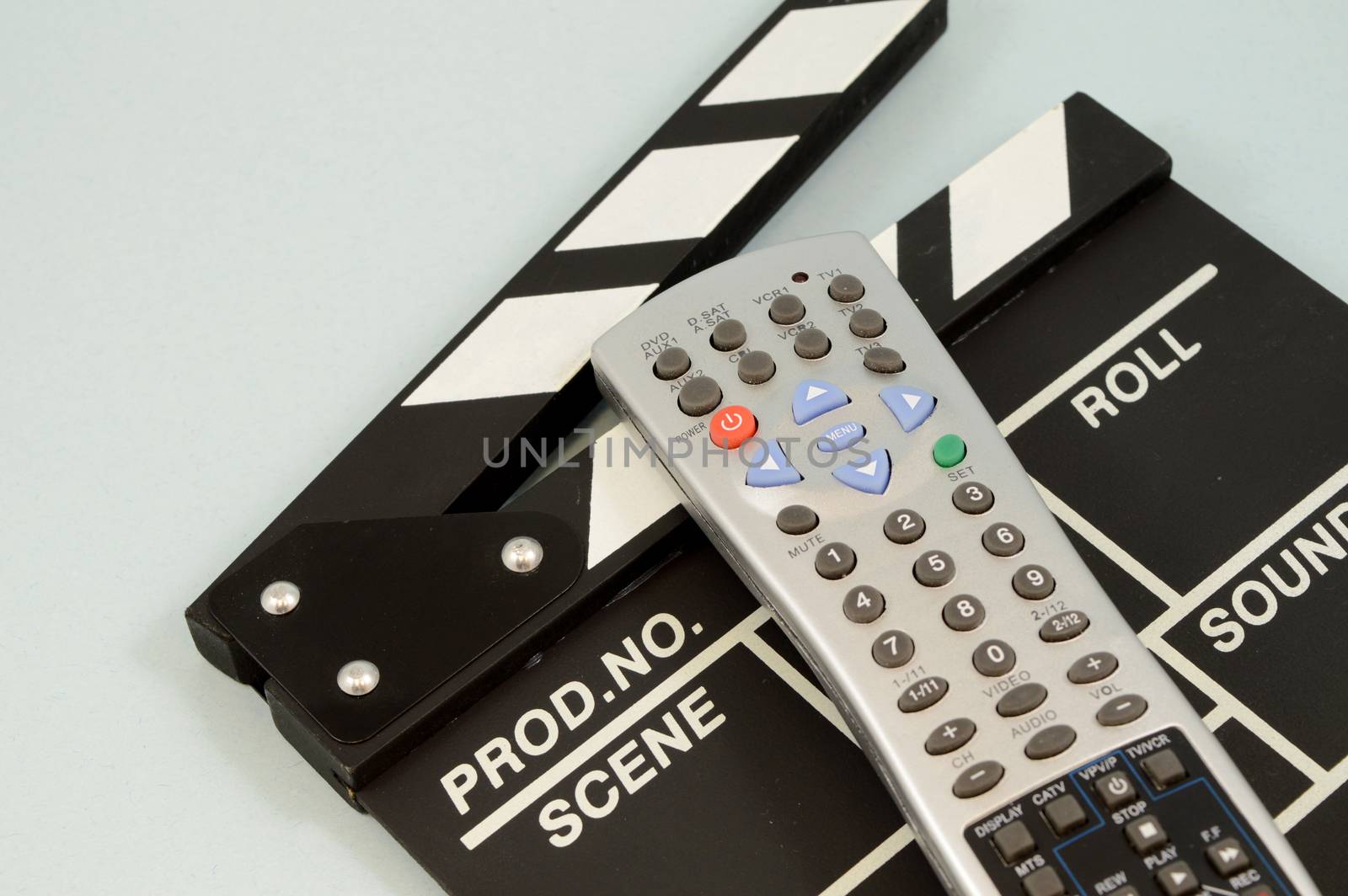 A closeup view of a remote control and directors clapboard for the entertainment industry.