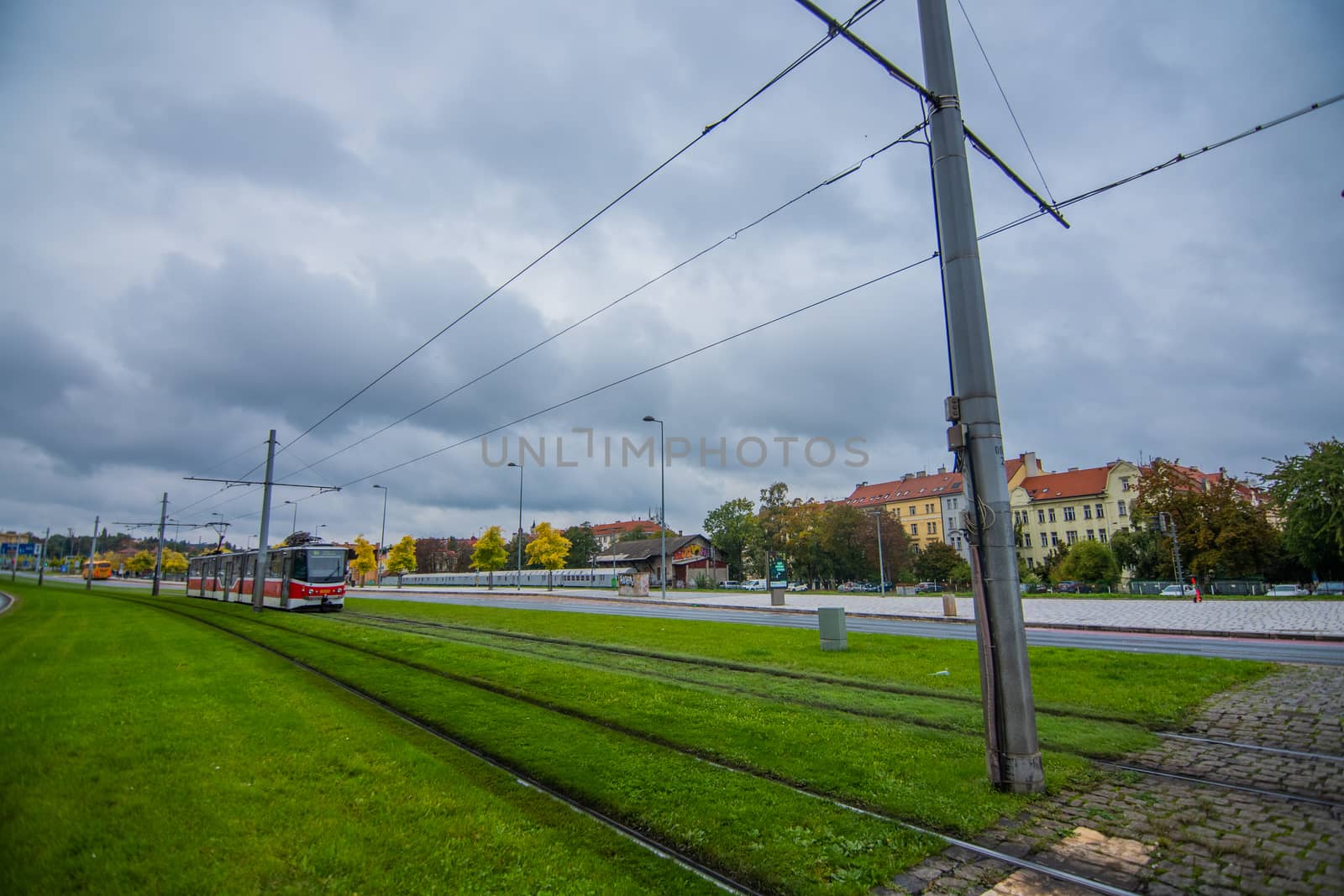 Tram driving in big avenue surrounded with big buildings in europe by gonzalobell