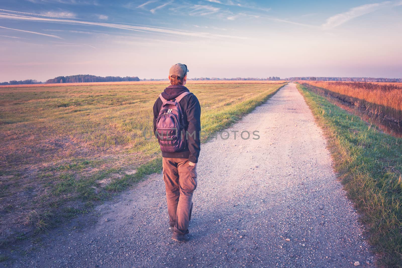 The man with the backpack goes the way, autumn view