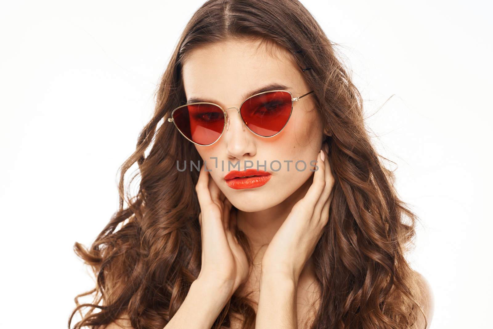 Portrait of brunette woman in sunglasses naked shoulders light background by SHOTPRIME