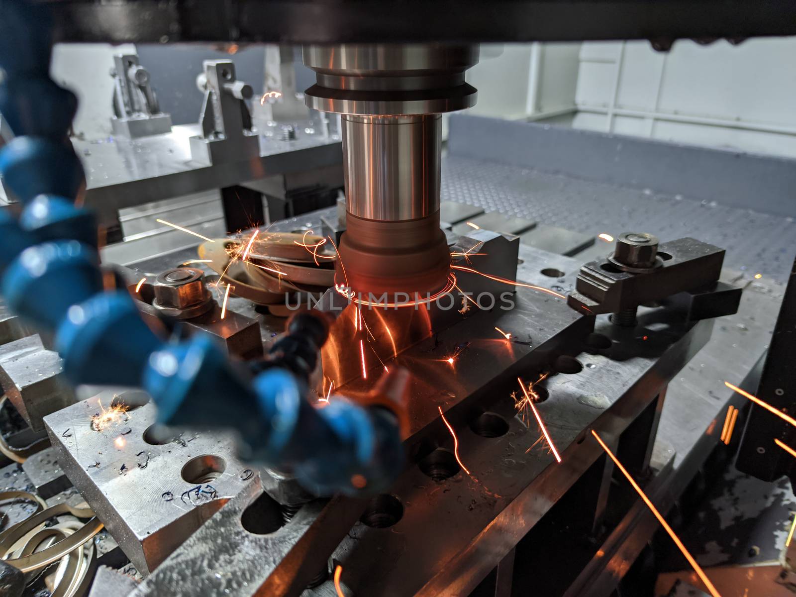cnc milling of hardened steel with sparks - closeup with selective focus and blur.
