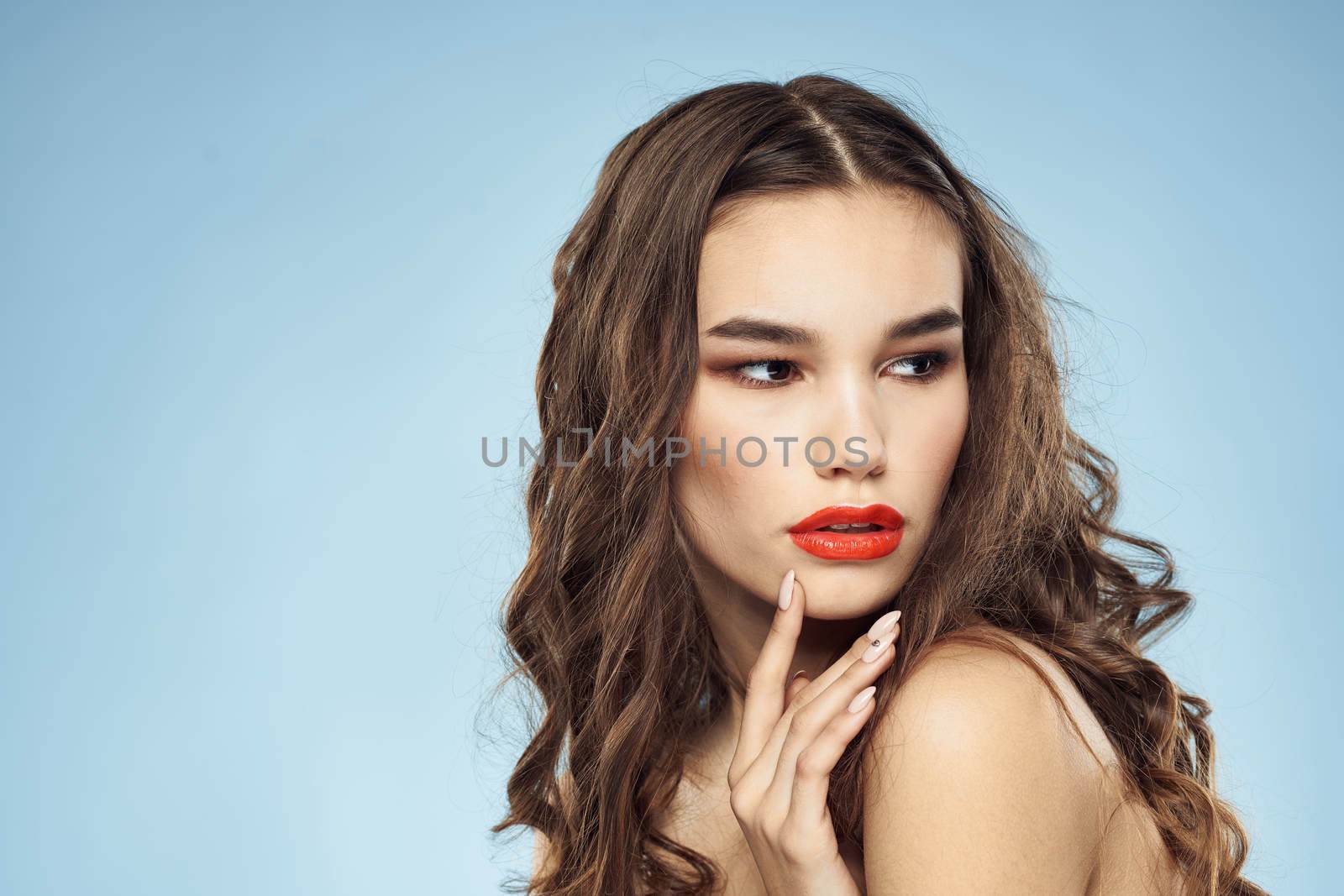 Beautiful woman naked shoulders hairstyle care bright makeup blue background by SHOTPRIME